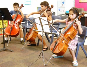 L-R: Jake Thomas (7), Katherine Swor (8) and Jenna Quiocho (8) refine their cello skills at the Maui Summer Music Festival 2009. Photo courtesy Malia Quiocho.