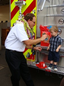 James “Kimo†Kino shares a moment with his grandson Hamilton at the pinning ceremony. Photo by Wendy Osher.