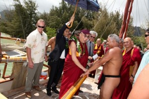 His Holiness the 14th Dalai Lama of Tibet climbs aboard the Hokulea