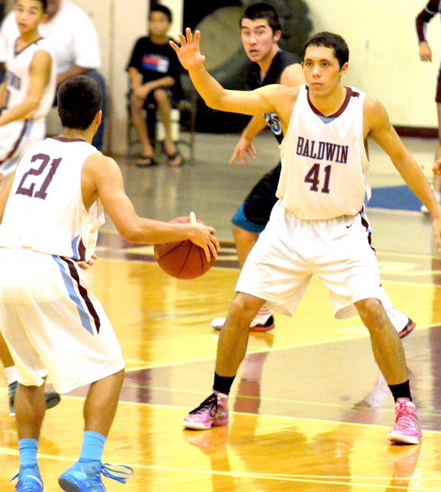 Baldwin's Jeremiah Badillo (21) looks to pass it to teammate Bradley Bowlin (41) as he tries back down King Kekaulike's Gabe Gunter. Photo by Rodney S. Yap.