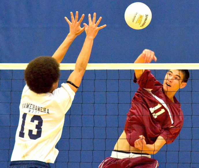 Baldwin High Schol's Trent Helle (11) hits past the block of Kamehameha Maui's Kahiau Andrade (13) in Tuesday's MIL boys volleyball action at the Warriors' gym. Photo by Rodney S. Yap.