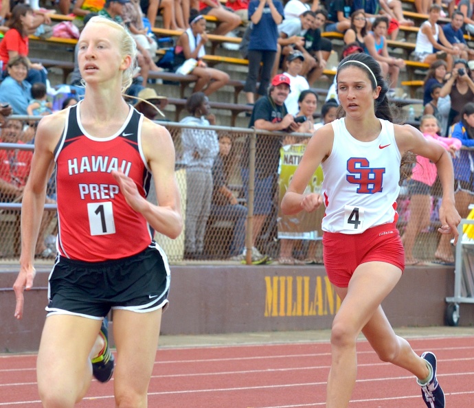 Hawaii Preparatory Academy's Zoe Sims pulls away from Seabury Hall's Dakota Grossman down the final stretch of their 3,000-meter run Saturday at Mililani High School. Both runners broke the meet record of 4:38.83 set in 1999 by Punahou's Victoria Chang. Sims was awarded the gold medal in 4:36.22 and Grossman the silver in 4:37.23. Photo by Rodney S. Yap.