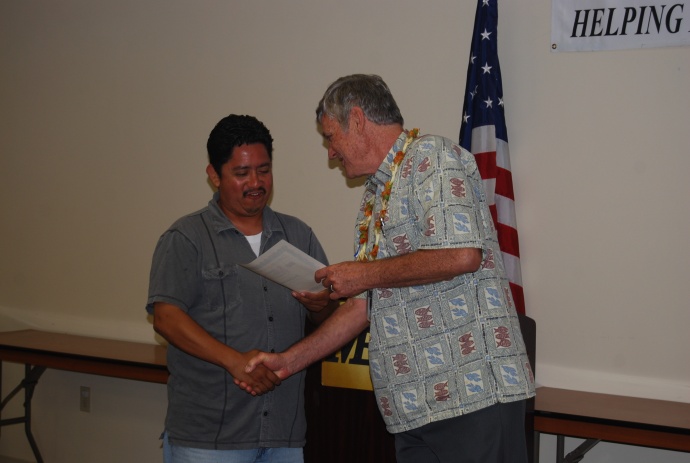 Graduate Jose Castellanos receives a certificate of achievement from Craig Swift, the director of the Maui Economic Opportunity's Business Development Center. Courtesy photo.