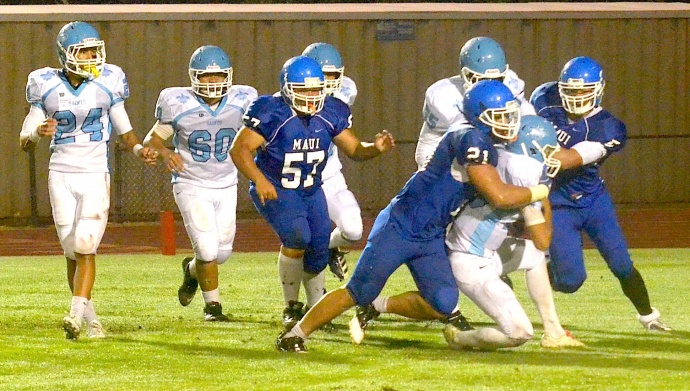 Maui High linebacker Moana Vainikolo (21) sacks Saint Francis' quarterback Blaze Umiamaka before teammates Brysen Kokubun (5) and Kyson Prest (57) can close. The Sabers beat the Saints 51-0. Photo by Rodney S. Yap.