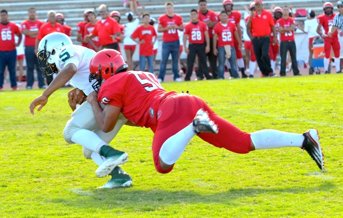 Lahainaluna's Hercules Mata'afa sacks Kapaa quarterback Fresno Masaniai during first-half action Saturday at War Memorial Stadium. The Lunas defeated the Warriors, 28-13. Photo by Rodney S. Yap.