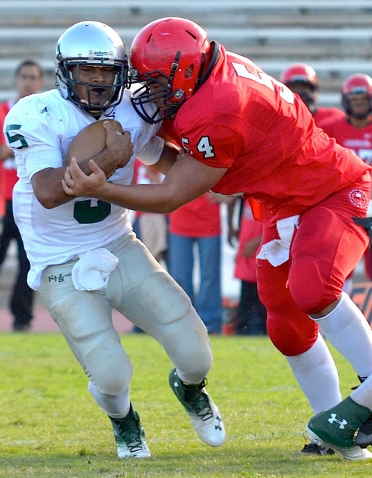 Lahainaluna's Connor Mowat (54) sacks Kapaa quarterback Fresno Masaniai (5) last week at War Memorial Stadium. Photo by Rodney S. Yap.