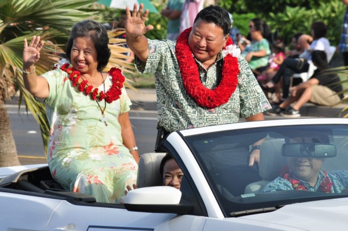 Mayor Arakawa and wife waving to the crowd at last year's Maui Fair Parade. File photo by Kit Zulueta, Sept. 2012, courtesy County of Maui facebook.