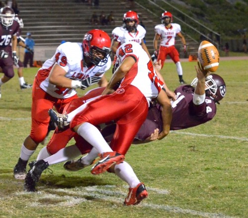 Lahainaluna's Jared Purdy and Gabriel Montano (behind 42) force this fumble from Baldwin kick returner Dusty Flores (43) as Lunas' Jonathan Lolohea (48) looks on. Photo by Rodney S. Yap.