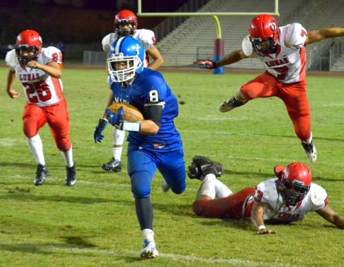 Maui High's Tyson Takabayashi (8) runs away from the Lahainaluna pursuit, including