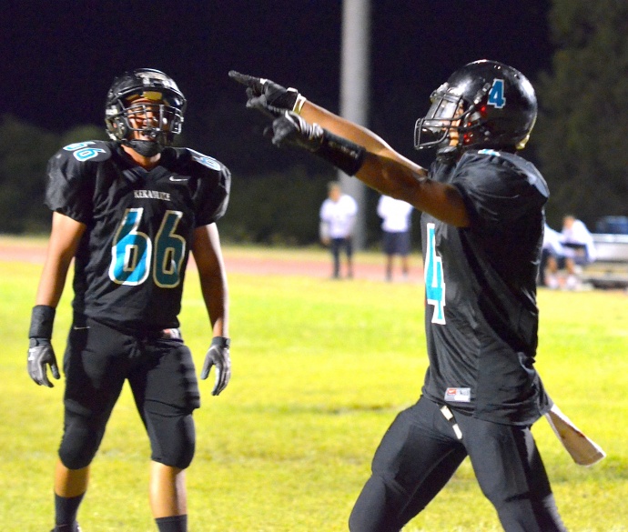 King Kekaulike's Kawika Homalon (4) points to the fans following his 1-yard touchdown run in the third quarter. Teammate Izaiah Manrique (66) looks on. Photo by Rodney S. Yap.