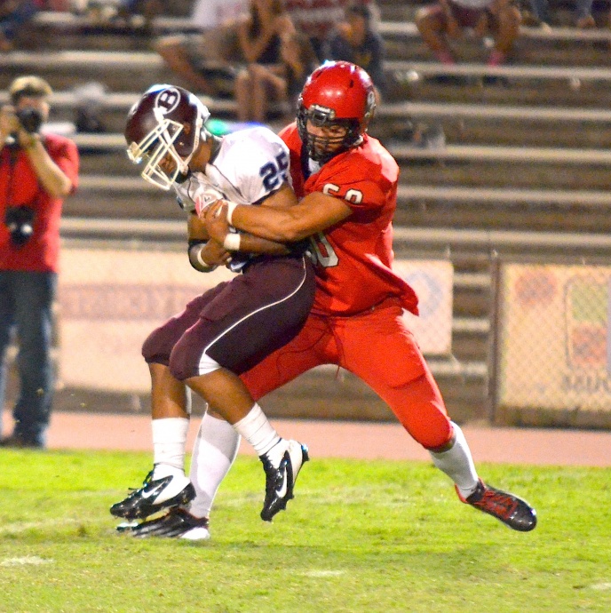 Lahainaluna defensive end Hercules Mata'afa wraps up Baldwin running back Keenan Lewis in the second quarter Friday. Photo by Rodney S. Yap.