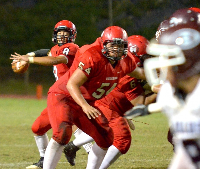 Lahainaluna quarterback Makoa Filikitonga eyes an open receiver from in the pocket behind center Connor Mowat. Photo by Rodney S. Yap.