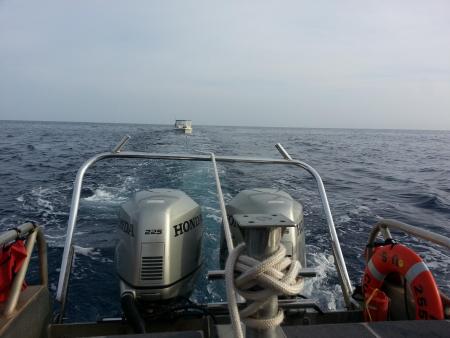 Crew members from Coast Guard Station Maui tow a 21-foot recreational vessel after it began to take on water approximately two miles north of Kahului, Maui, Nov. 20, 2013. Open lines of communication between multiple agencies allowed for assets to respond quickly, locate and save the lives of two fishermen. (US Coast Guard photo)