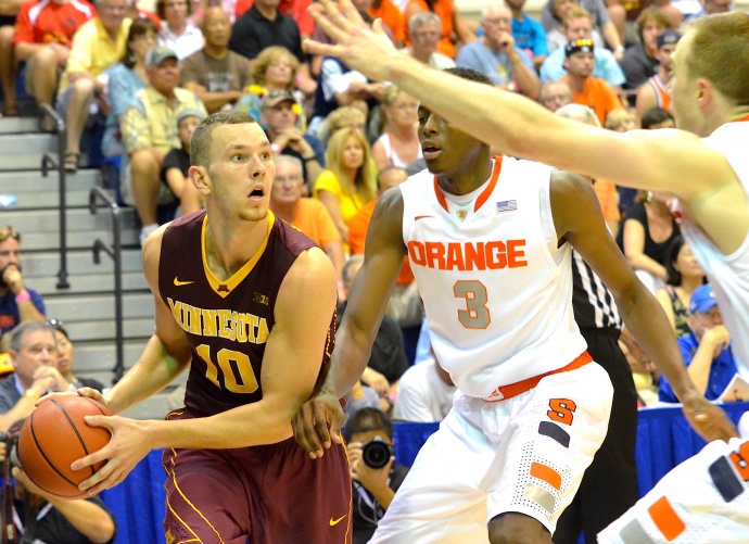 Minnesota's Oto Osenieks (10) looks for an open man as Syracuse's Jerami Grant applies defensive pressure. Photo by Rodney S. Yap.