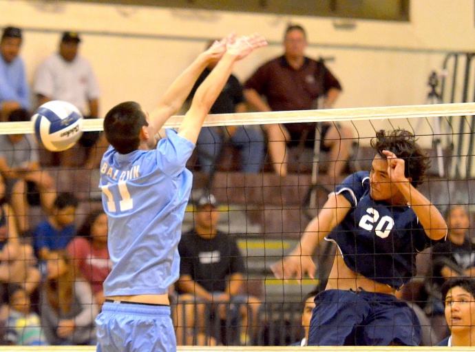 Kamehameha Maui's Keawe Rindlisbacher hits this ball past the block of Baldwin's Trent Helle in Wednesday's MIL match at Baldwin's Jon Garcia Gym. Photo by Rodney S. Yap.