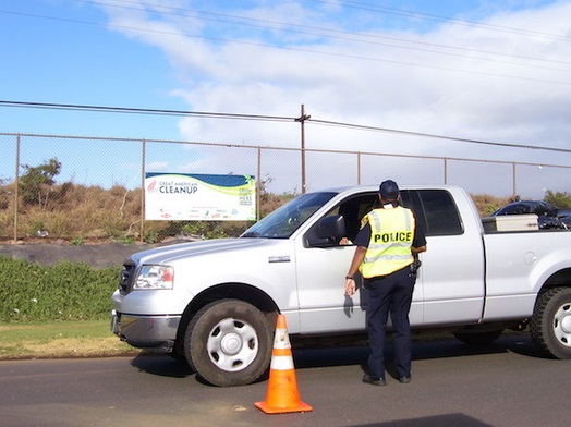 A police officer talks to a driver about laws relating to uncovered loads during a 2010 educational campaign. Courtesy file photo.