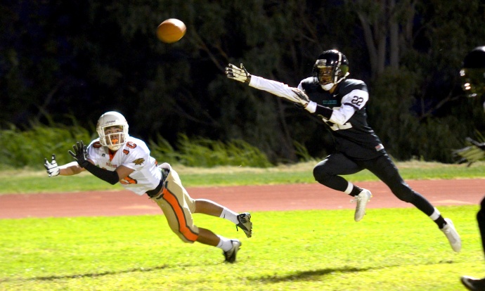 Pac-Five wide receiver Tsubasa Brennan dives for this first-half reception Saturday at King Kekaulike as Na Alii defensive back Corry Brown defends on the play. Photo by Rodney S. Yap.