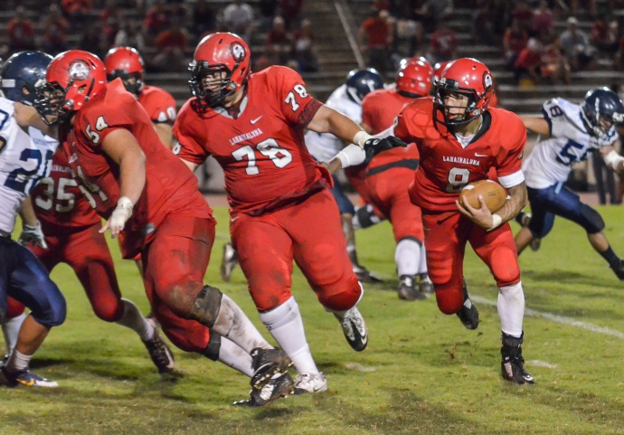 Lahainaluna quarterback Makoa Sione Filikitonga-Lukela (8) has done plenty of damage this year running behind his big offensive line. Photo by Rodney S. Yap.