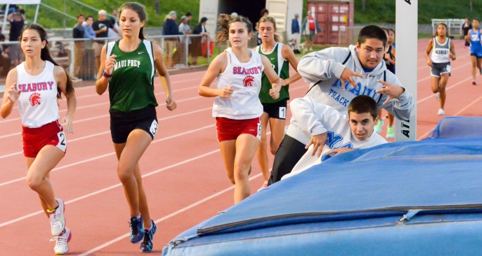 Maui High's Ericson Hirose and Eli Cobb photo bomb the girls 3,000-meter run Friday. Photo by Rodney S. Yap.