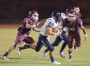 Kamehameha Maui's Covy Cremer (22) tries to get around the Baldwin defense Saturday. Photo by Rodney S. Yap.