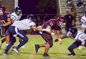 Baldwin's Chazz Sa'u (10) puts his head down as he battles for extra yardage against Kamehameha Maui's defense. Photo by Rodney S. Yap.