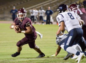 Baldwin's Chazz Sa'u (10) looks to get into the end zone as Kamehameha Maui linebacker Michael Kahula (8) looks to make a stop on Sa'u. Photo by Rodney S. Yap.