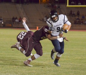 Kamehameha Maui's Kai Segundo (9) tries to break free from a Baldwin would-be tackler. Photo by Rodney S. Yap.