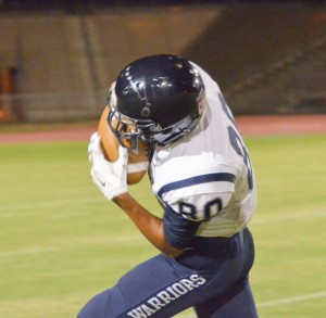 Kamehameha Maui's Nathan Facuri (80) hauls in this long pass from quarterback Kainoa Sanchez in the second half Saturday against Baldwin. Photo by Rodney S. Yap.