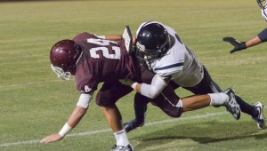 Baldwin running back Kamaki Gouveia (24) fights for extra yardage Saturday against Kamehameha Maui. Photo by Rodney S. Yap.