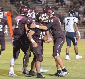 Baldwin's Chazz Sa'u (10) is congratulated by teammates after catching a tipped pass for touchdown against Kamehameha Maui. Photo by Rodney S. Yap.