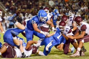 Maui High's Soane Vaohea (1) runs into all kinds of traffic including Baldwin's La'akea Kahoohanohano-Davis (21) Friday. Photo by Rodney S. Yap.