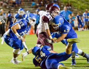 Maui High's Josh Shirota and Mahonri Anitema (54) swarm all over Baldwin's Kamaki Gouviea. Photo by Rodney S. Yap.