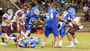 Maui High's Nathan Nunez (34) tries to bring down Baldwin's La'akea Kahoohanohano-Davis. Photo by Rodney S. Yap.