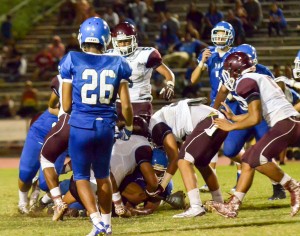 Maui High's Israel Emelio emerges with the ball after he recovers a Baldwin fumble midway through the third quarter Friday. Photo by Rodney S. Yap.