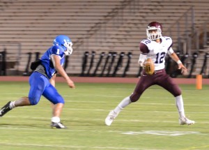 Baldwin's Chayce Akaka looks for someone to throw to in the closing seconds of Friday's game against Maui High as Saber Soane Vaohea gives chase. Photo by Rodney S. Yap.