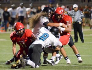 Lahainaluna'S Donovan Defang (21) tries to get into the end zone against King Kekaulike's goal-line defense led by Noah Clayton (8). Photo by Rodney S. Yap.