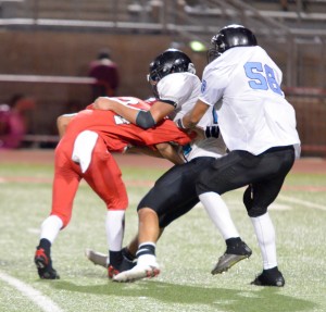 King Kekaulike's defense makes a play behind the line of scrimmage against Lahainaluna Saturday. Photo by Rodney S. Yap.