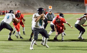 King Kekaulike quarterback Cameron Russell scans the field for an open receiver. Photo by Rodney S. Yap.