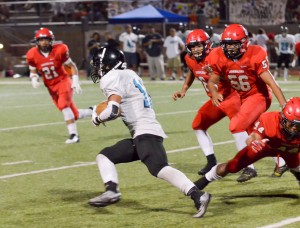 King Kekaulike's Kawika Akahi (11) finds an opening in the Lunas' defense. Akahi scored his team's only touchdown on this 75-yard run in the third quarter. Photo by Rodney S. Yap.