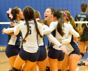 Kamehameha Maui girls volleyball team celebrates after beating King Kekaulike in four sets Friday. Photo by Rodney S. Yap.