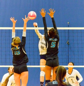 Kamehameha's Kanilea Nomura hits through the block of King Kekaulike's Chandler Cowell (5) and Rose Love (5). Photo by Rodney S. Yap.