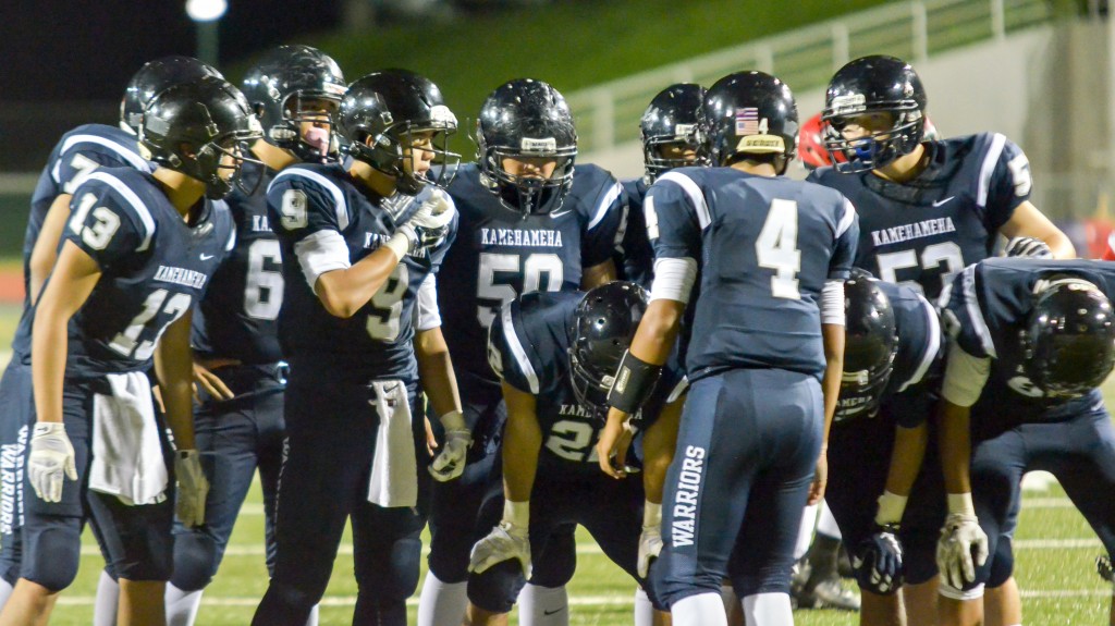 Kamehameha Maui quarterback Kainoa Sanchez (4) leads the offensive huddle Friday against Lahainaluna. Photo by Rodney S. Yap.