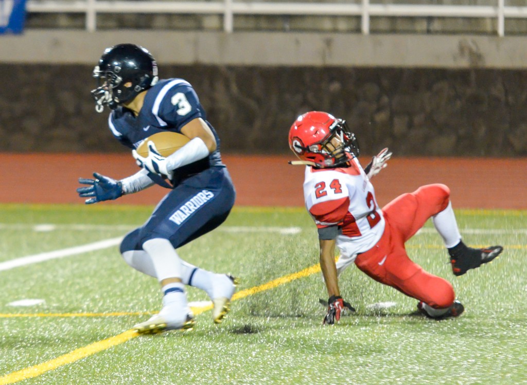 Kamehameha Maui's Ekolu Watanabe (3) jukes Lahainaluna's Elijah Ragudo (24) while returning a punt Friday. Photo by Rodney S. Yap.