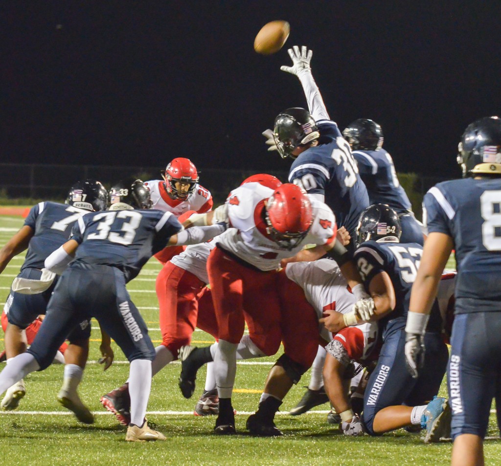 Kamehameha Maui's Keaghan Gomes (30) reaches up to block this point after try by Lahainaluna's