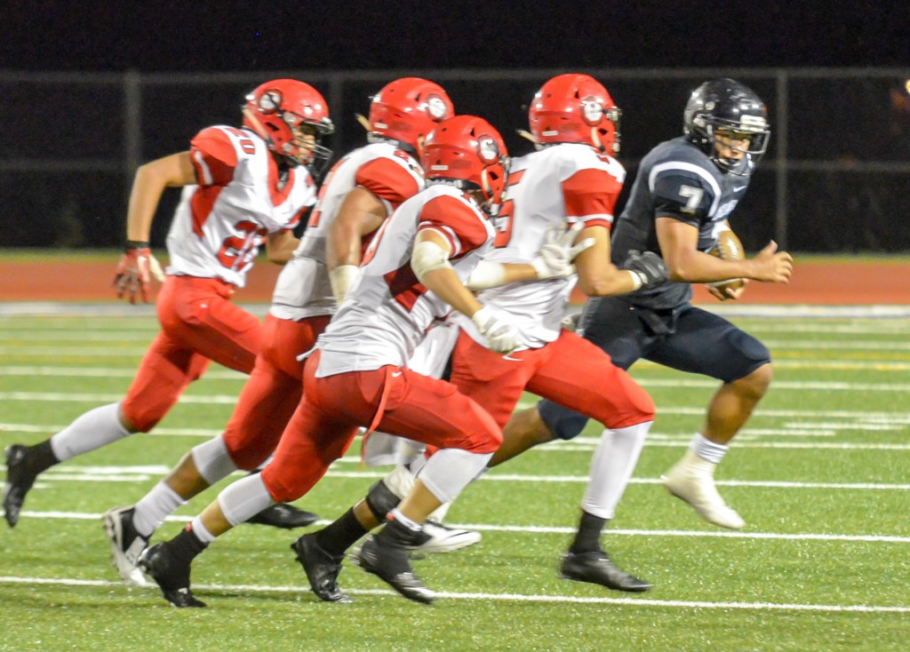 Kamehameha Maui running back Ikaika Chong Kee can not avoid the pursuit of Lahainaluna defenders. Photo by Rodney S. Yap.