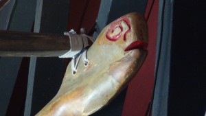 Restored and painted hand-carved ama, or outrigger, hanging with its koa canoe at Nalu's South Shore Grill. Photo by Kiaora Bohlool.