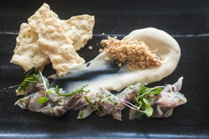 Chef Isaac Bancaco's dish of Opelu, Opakapaka, Brandade, fine herbs and lavosh for the Hawai'i Seafood Month launch party at MiGRANT Maui. Photo by Mieko Horikoshi.