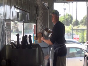 Chef Kyle Kawakami works in his gourmet food truck at Maui Fresh Streatery. Photo by Kiaora Bohlool.