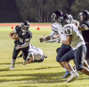 King Kekaulike quarterback Cameron Russell looks for running room in traffic near the goal line Saturday. Photo by Rodney S. Yap.