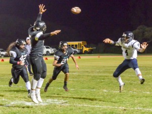 Kamehameha Maui quarterback Kainoa Sanchez throws this pass to Ekolu Watanabe while King Kekaulike's defense closes in. Photo by Rodney S. Yap.